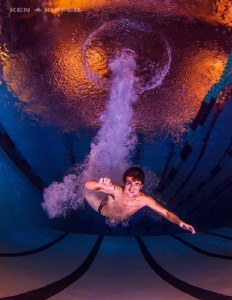 High school diver entering the water at a very high rate ... by Ken Kiefer 